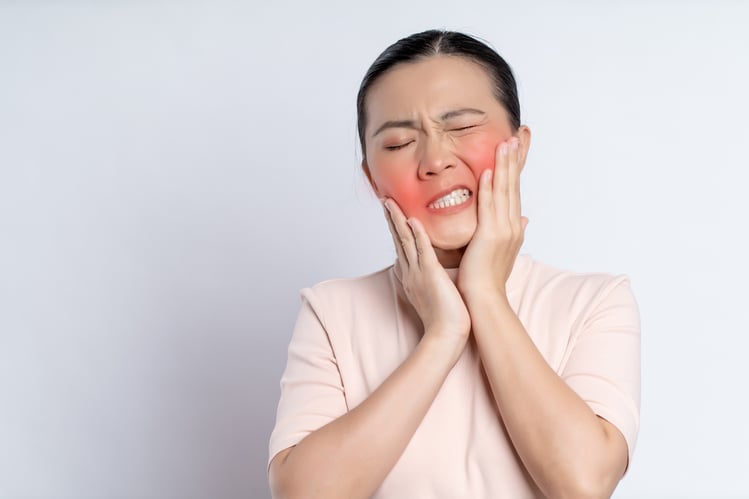 asian-woman-was-sick-with-toothache-standing-isolated-white-background